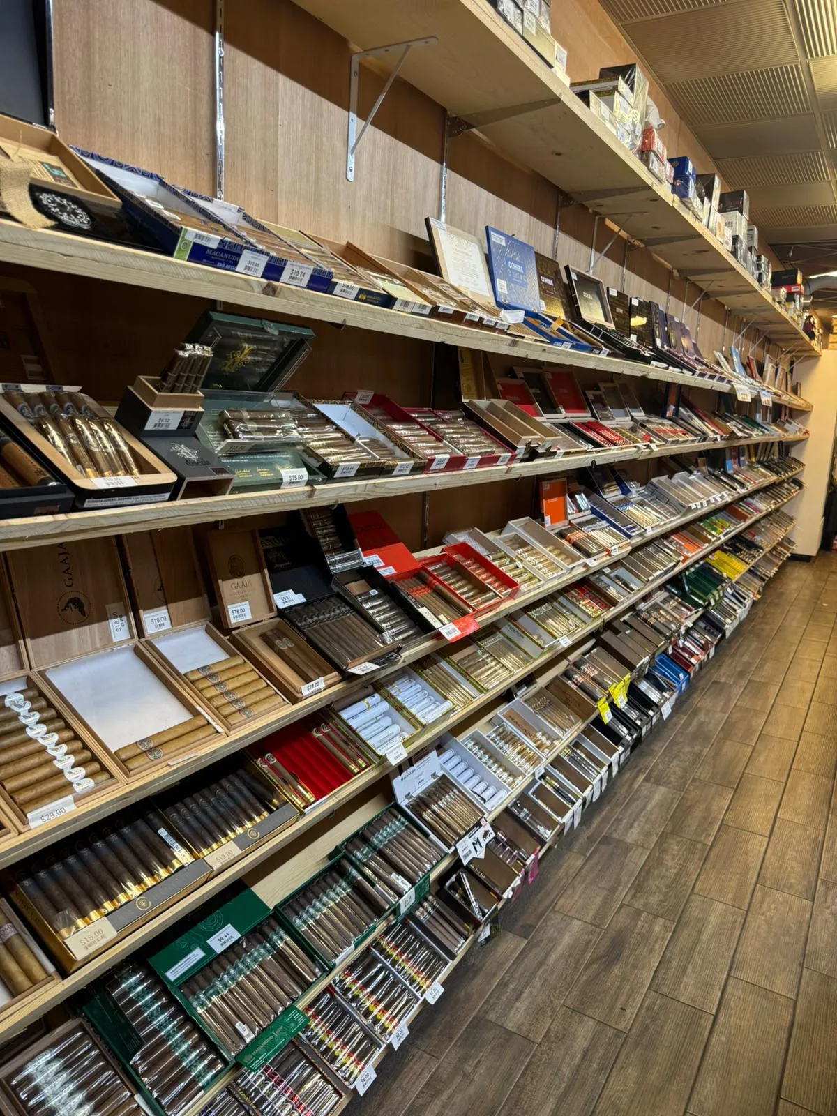 The humidor aisle at Cigar Heaven Webster — walls of cigar boxes from mainstream and boutique brands.